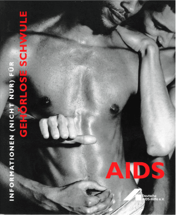 Front cover of a magazine showing a man being tenderly embraced from behind by another man.