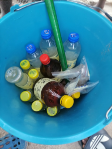 a bucket filled with bottles containing water samples